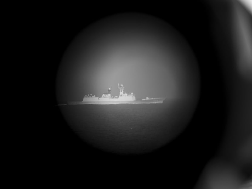 A Chinese People’s Liberation Army Navy frigate in the South China Sea, seen through the bridge binoculars on the USS Chancellorsville, on March 23. The fear of Beijing turning the South China Sea into a ‘Chinese lake’ is fast becoming a reality. Photo: The New York Times