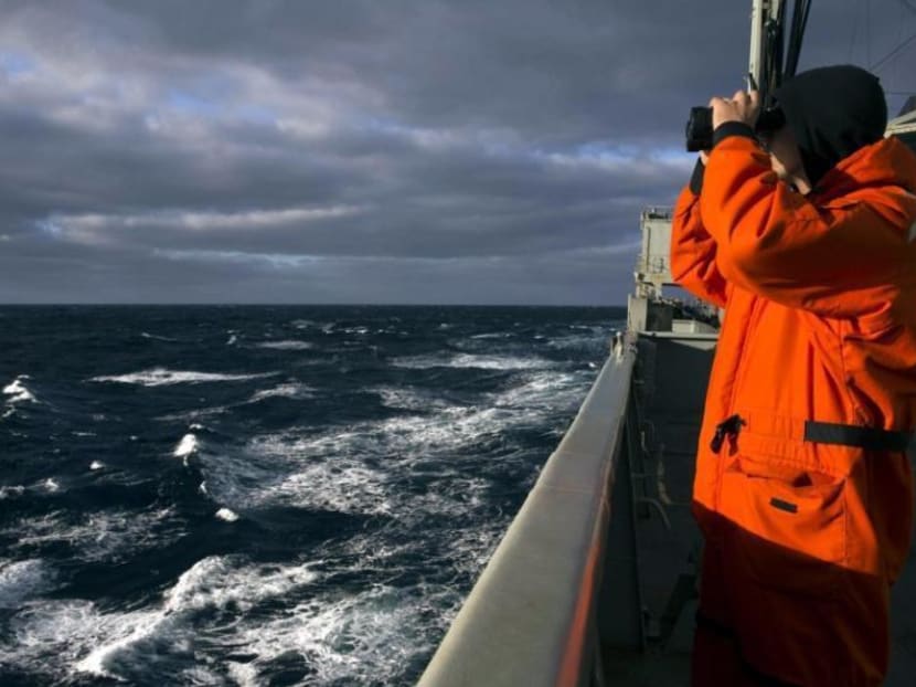File picture of a crew member on Australian Navy ship the HMAS Success looking for Flight MH370 taken on March 31, 2014. Photo: Reuters