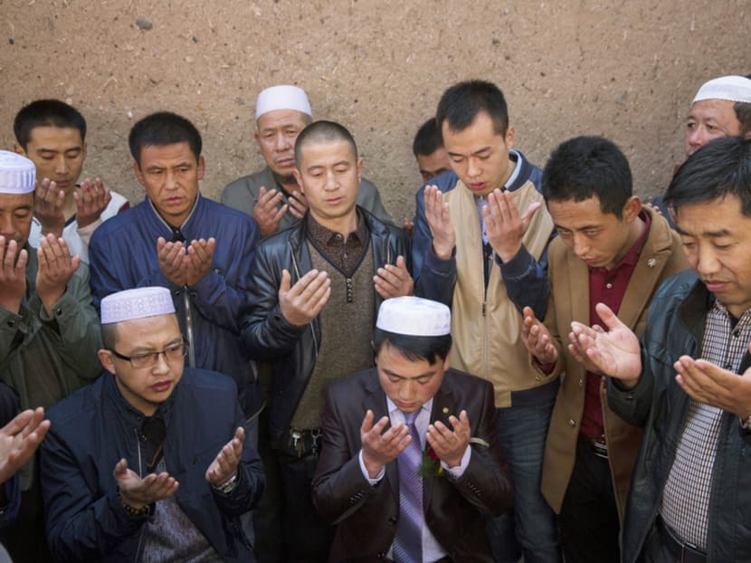 Hui men in prayer at a wedding in Linxia, China. Religious freedoms here stand in contrast to many parts of officially atheist China, where it is a crime to operate Islamic schools and people under 18 are barred from entering mosques. 

Photo: The New York Times