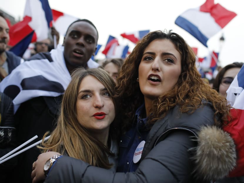 Supporters of French independent centrist presidential candidate, Emmanuel Macron wait for the results outside the Louvre museum in Paris, France, Sunday, May 7, 2017. Photo: AP