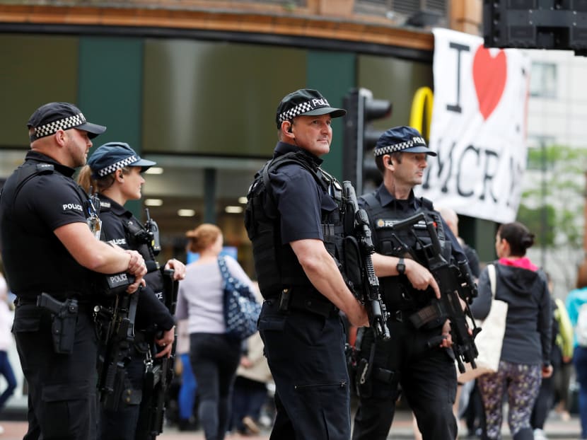 Armed police officers stand on duty in central Manchester, Britain, May 28, 2017. Photo: Reuters
