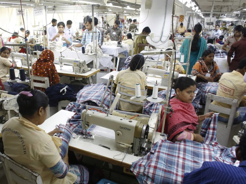 Employees working in a garment factory in Bangladesh. Robots are useful in the automotive industry, with its high volumes, but are decades away from displacing skilful fingers in the clothing sector. Photo: Reuters