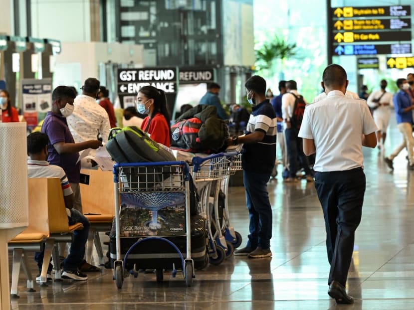 Travellers at Changi International Airport in Singapore on March 15, 2021.