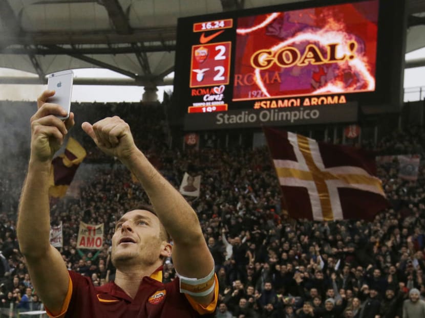 Francesco Totti taking a selfie with the adoring Roma crowd behind him after his final game with the club. He has played for only Roma throughout his club career. Photo: AP