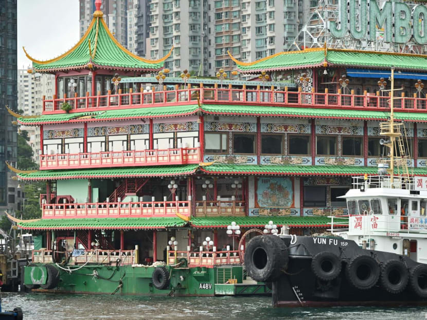 A tugboat pulls up beside Hong Kong's Jumbo Floating Restaurant, an iconic but aging tourist attraction designed like a Chinese imperial palace, before being towed out of Aberdeen Harbour on June 14, 2022, after years of revitalisation efforts went nowhere.