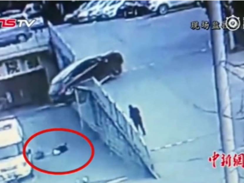 Surveillance footage showed the mother crawling over to her child to protect him using her body. Photo: Handout via South China Morning Post
