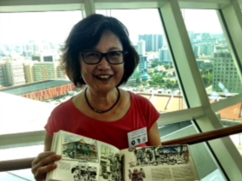 Urban Sketchers founder and artist Tia with the group's first book, Singapore Sketchers, published in 2011. Their second book, depicting memories of artists, will be ready in May. Photo: Leong Wai Kit/CNA
