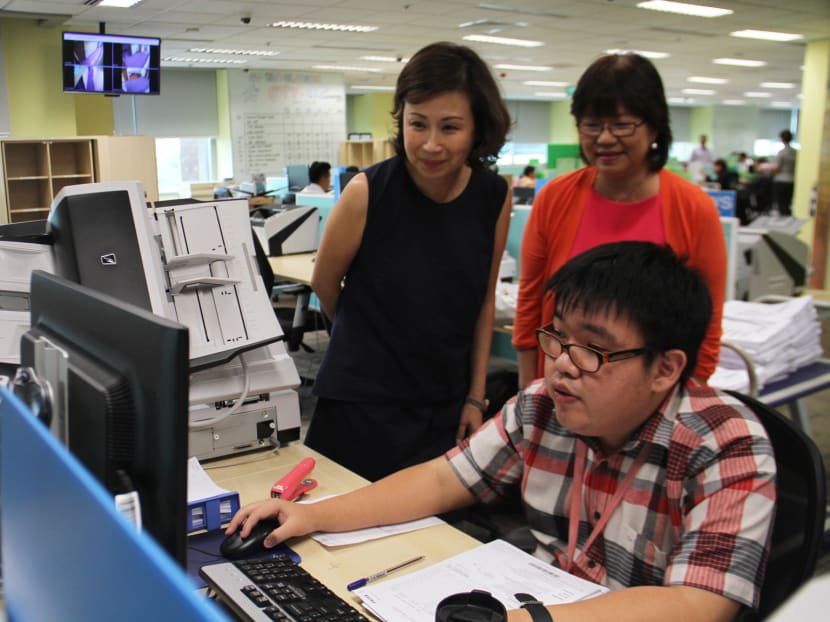 UOB Scan Hub made slight modifications to its environment as part of the bank's move to have a more inclusive workspace. From left: Ms Susan Hwee, UOB Group Head of Technology and Operations; Ms Denise Phua, President, the Autism Resource Centre; Mr Feng Zhi Hua, Clerical Assistant, UOB Scan Hub. Photo: Jaslin Goh
