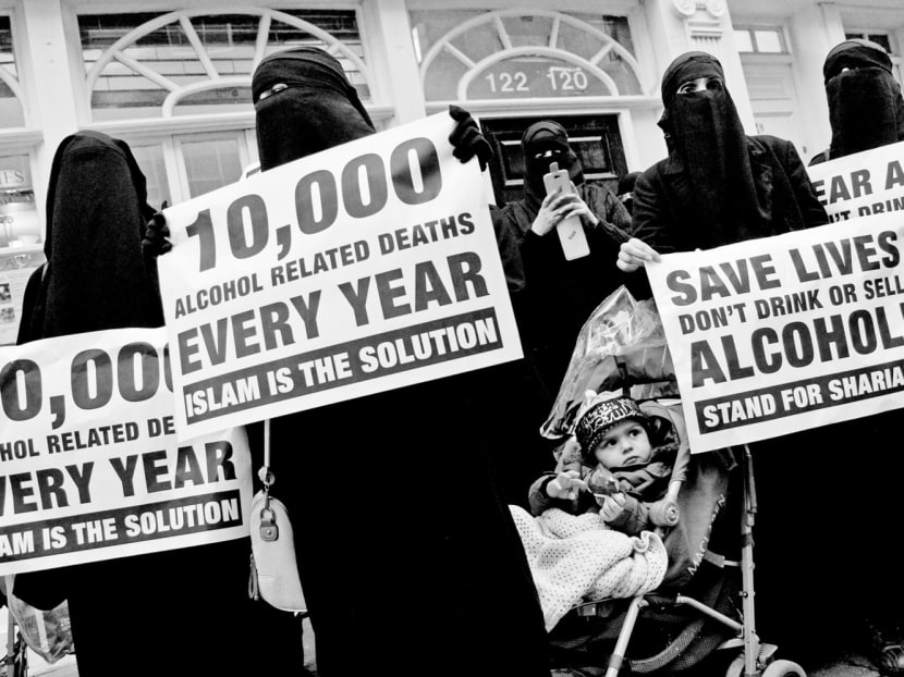 Demonstrators at a rally organised in London by preacher Anjem Choudary, who has been convicted by a British court of using online lectures and messages to encourage support for Islamic State. Photo: Reuters