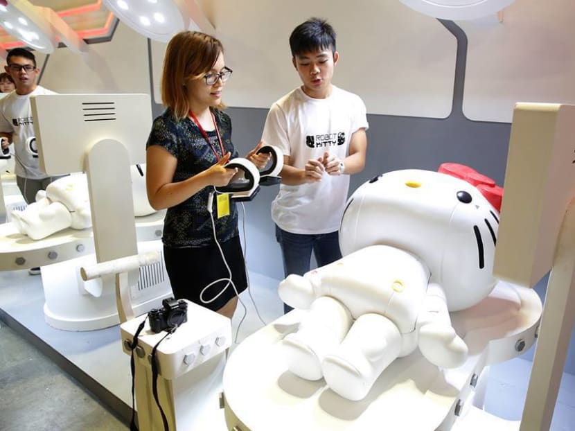 Visitors need to use a defibrillator to recharge Robot Kitty. Photo: Damien Teo