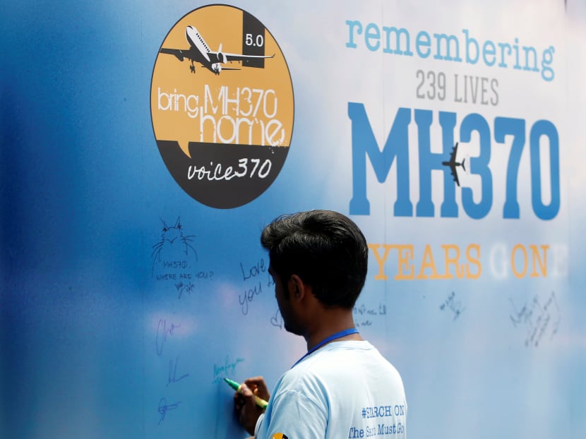 A man writes on a message board for passengers, onboard the missing Malaysia Airlines Flight MH370, during its fifth annual remembrance event in Kuala Lumpur, Malaysia, March 3, 2019.