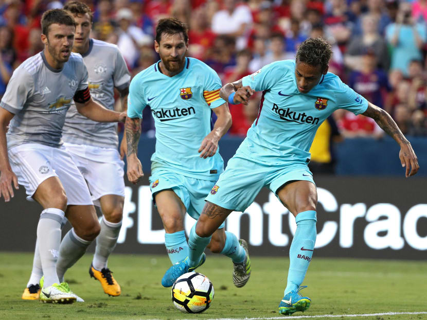 Barcelona's Neymar (right) about to score against Manchester United as teammate Lionel Messi watches on. According to United manager Jose Mourinho, Real Madrid and Barcelona have the edge over clubs like United because the best player sin the world, including Messi and Neymar, play for them. Photo: AFP