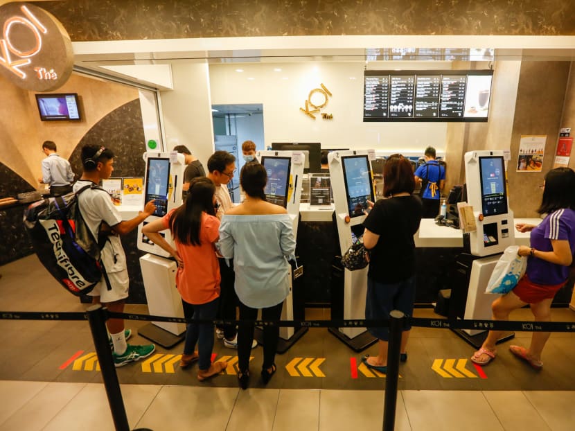 Customers practicing social distancing as they order from the automated kiosks one metre apart from each other on March 20, 2020.