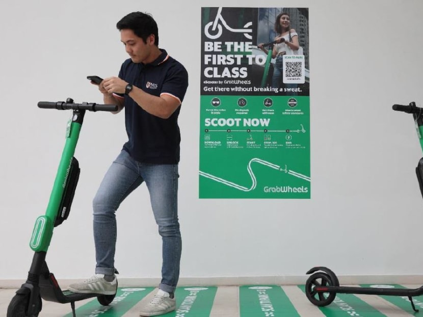 A student at the National University of Singapore unlocks an e-scooter using the GrabWheels beta app. A student at the National University of Singapore unlocks an e-scooter using the GrabWheels beta app.