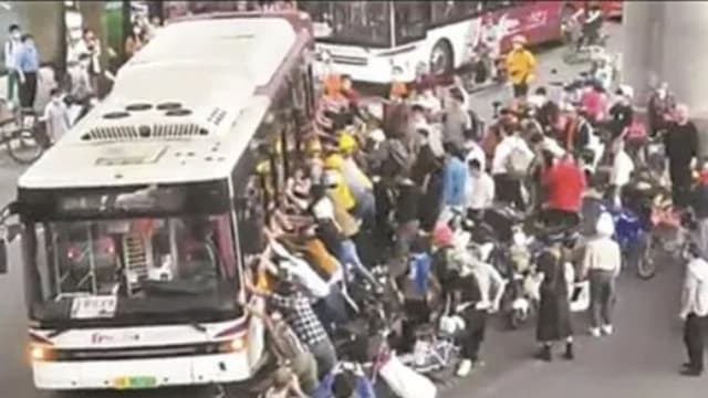 中国送餐员被卷入巴士车底 上百人抬车救人