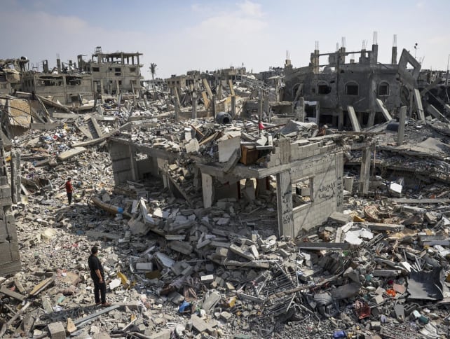 People inspect the damage amid the rubble of buildings destroyed during Israeli bombardment in Khan Yunis, on the southern Gaza Strip on April 16, 2024, as fighting continues between Israel and the Palestinian militant group Hamas.