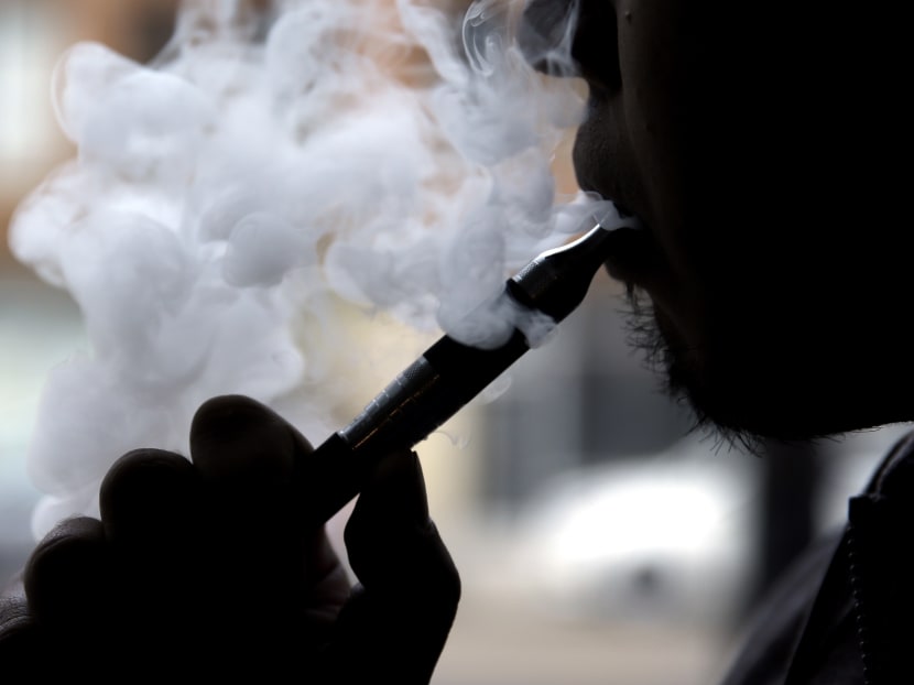 Mr Daryl Cura demonstrates an e-cigarette at Vape store in Chicago. Some schools are taking stricter measures to keep e-cigarettes out of students’ hands, even punishing possession of the devices more harshly than regular cigarettes, because the devices, sometimes also known as vaporizers, can also be used for illegal substances like marijuana. Photo: AP