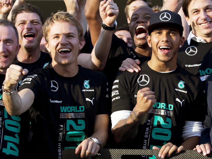 Hamilton (right) and Rosberg celebrating Mercedes winning the constructors’ title for the first time in the team’s history. Photo: AP