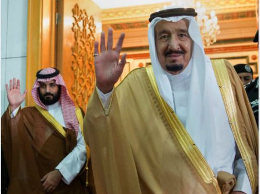 Saudi King Salman (right) and Defense Minister and Deputy Crown Prince Mohammed bin Salman waving as they leave the hall after talks with the British prime minister, in Riyadh, Saudi Arabia on April 5, 2017. Photo: Saudi Press Agency via AP