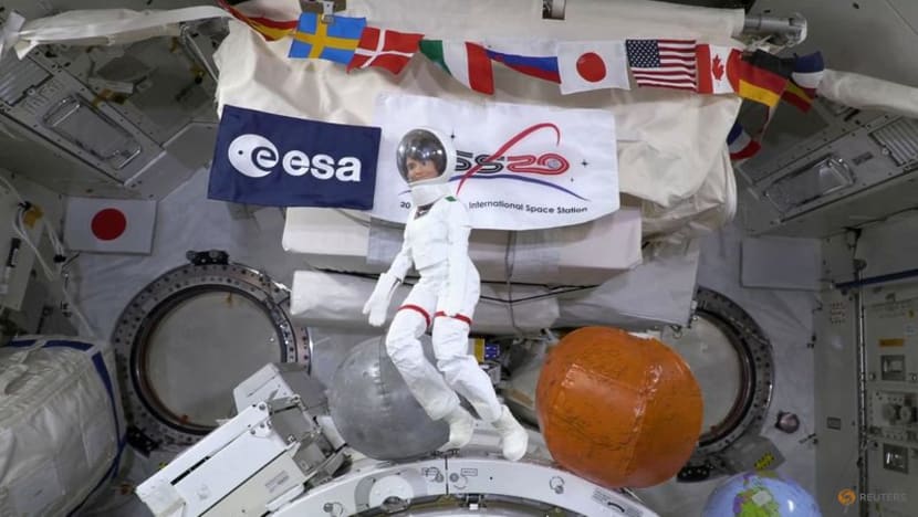 Space station's Italian commander, with lookalike Barbie, tells girls about science in orbit