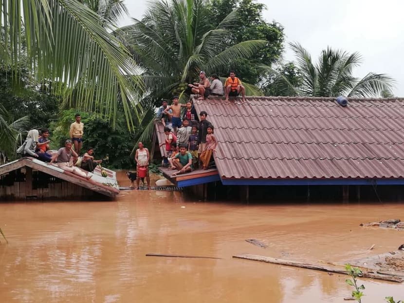 Photo of the day: Villagers are seen stranded on a roof after a hydropower dam collapsed and flooded six villages of Sanamxay district in in Attapeu Province, Laos, state media reported on Tuesday (July 24). Photo: ABC Laos News