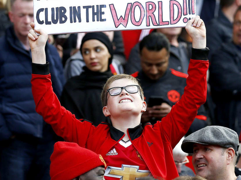 A young fan holding up a sign for United’s David de Gea. The goalkeeper almost moved to Real Madrid, but received a warm welcome from supporters. Photo: AP