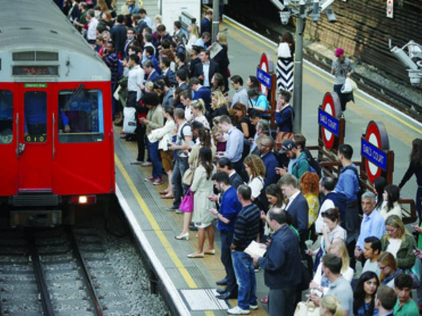Commuters at Earls Court station in London. Despite the breakdowns, strikes and even inclement weather that bring them to a halt every now and then, London’s underground trains are still the best way to get around the city. Photo: Reuters