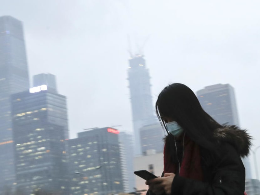 A woman wears a mask thanks to Beijing's smog. AP file photo