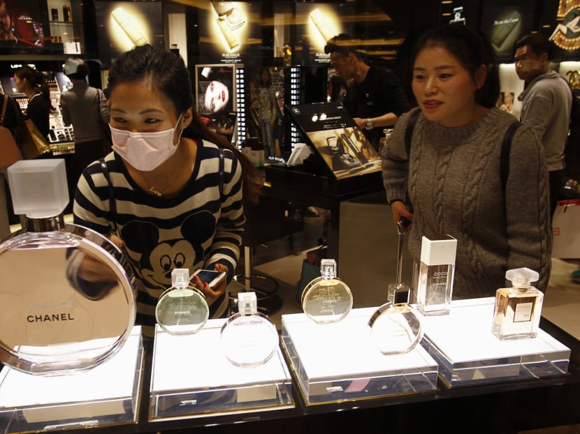 Chinese visitors shopping in a Hong Kong mall. Due to high luxury taxes and aggressive pricing strategies, luxury goods in China can be more expensive than the same item in Hong Kong, Japan or Europe. Photo: Reuters