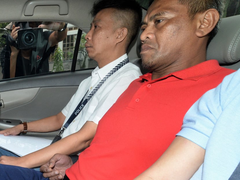 Mohammad Rosli Abdul Rahim (in red), charged with murder of his flatmate in Teck Whye, arriving at the State Courts on August 18, 2017. Photo: Robin Choo/TODAY