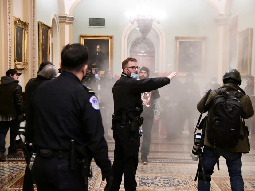 A security officer gestures after supporters of US President Donald Trump breached security defences at the US Capitol in Washington on Jan 6, 2021. A security officer gestures after supporters of US President Donald Trump breached security defences at the US Capitol in Washington on Jan 6, 2021.
