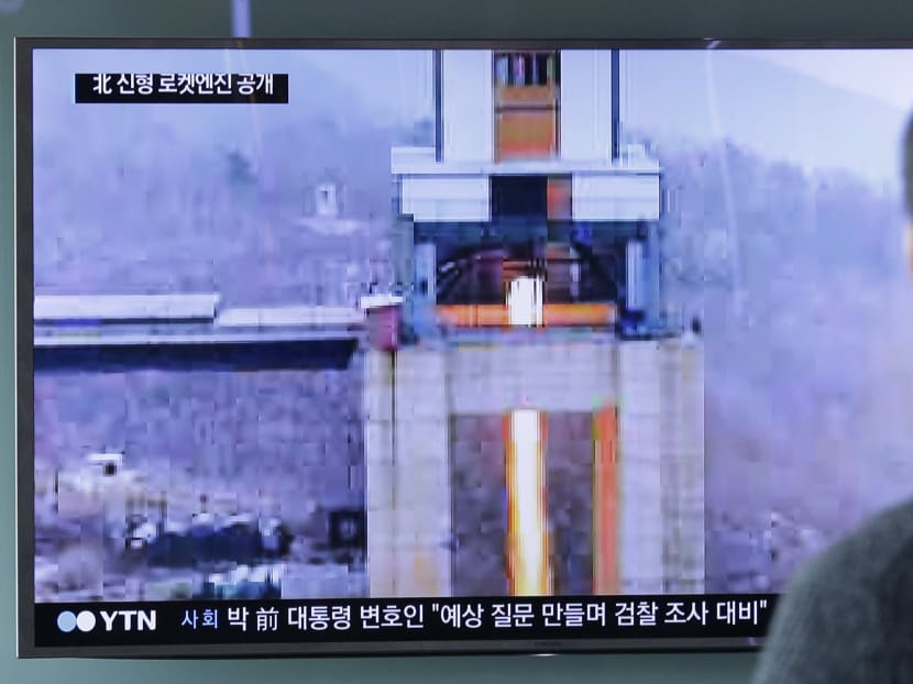 A man watches a TV news programme showing an image that North Korea's Rodong Sinmun newspaper reported of a ground test of a new type of high-thrust rocket engine that leader Kim Jong Un is calling a revolutionary breakthrough for the country's space programme. Photo: AP