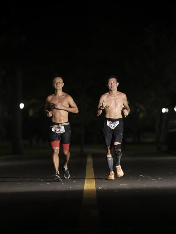 Joshua Toh (left) and Deric Lau running through the night during the Backyard Ultra World Team Championships held between Oct 15 and Oct 17, 2022.