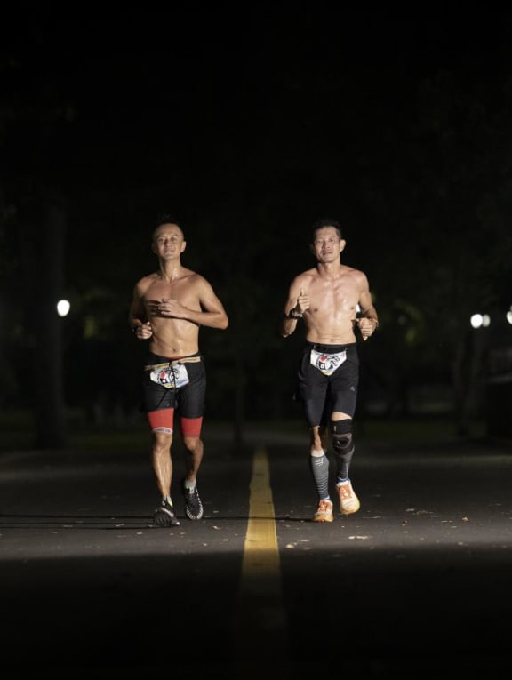 Joshua Toh (left) and Deric Lau running through the night during the Backyard Ultra World Team Championships held between Oct 15 and Oct 17, 2022. Joshua Toh (left) and Deric Lau running through the night during the Backyard Ultra World Team Championships held between Oct 15 and Oct 17, 2022.