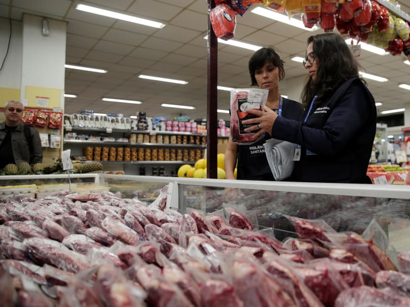Members of the Public Health Surveillance Agency collect meats to analyse in their laboratory, at a supermarket in Rio de Janeiro, Brazil. Photo: Reuters
