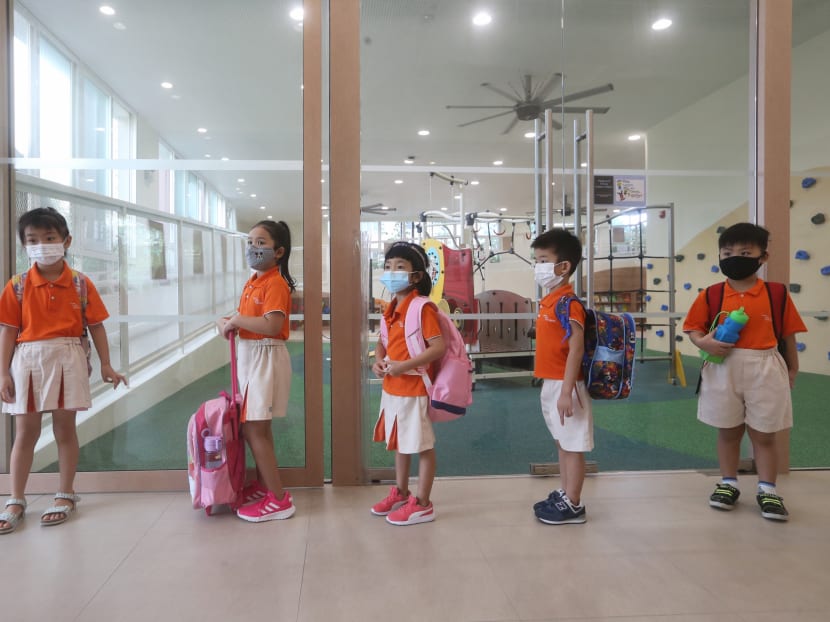 Young children from NTUC First Campus’ My First Skool at 50 Sengkang West Way waiting to be led into class on June 2, 2020.