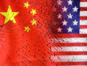 FILE PHOTO: U.S. and Chinese flags are seen through broken glass in this illustration taken, January 30, 2023. REUTERS/Dado Ruvic/Illustration