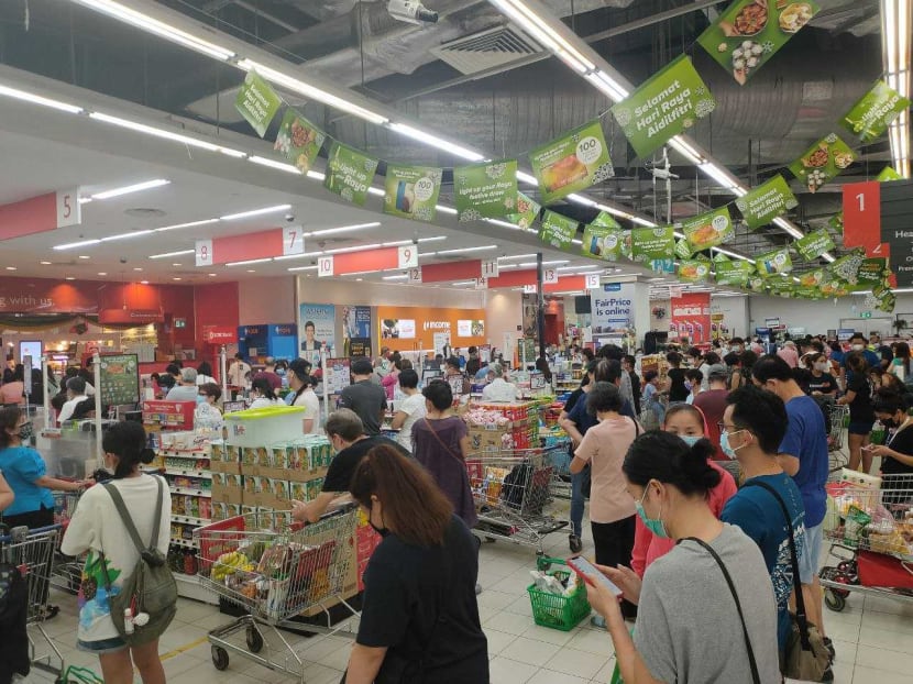 Long, snaking queues formed at FairPrice Xtra supermarket at Nex mall in Serangoon on May 14, 2021. Long, snaking queues formed at FairPrice Xtra supermarket at Nex mall in Serangoon on May 14, 2021.
