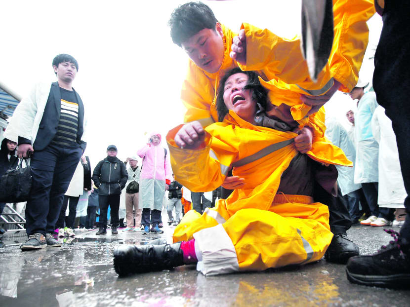 A distraught relative at a port in Jindo yesterday where other 
family members have gathered. Photo: Reuters