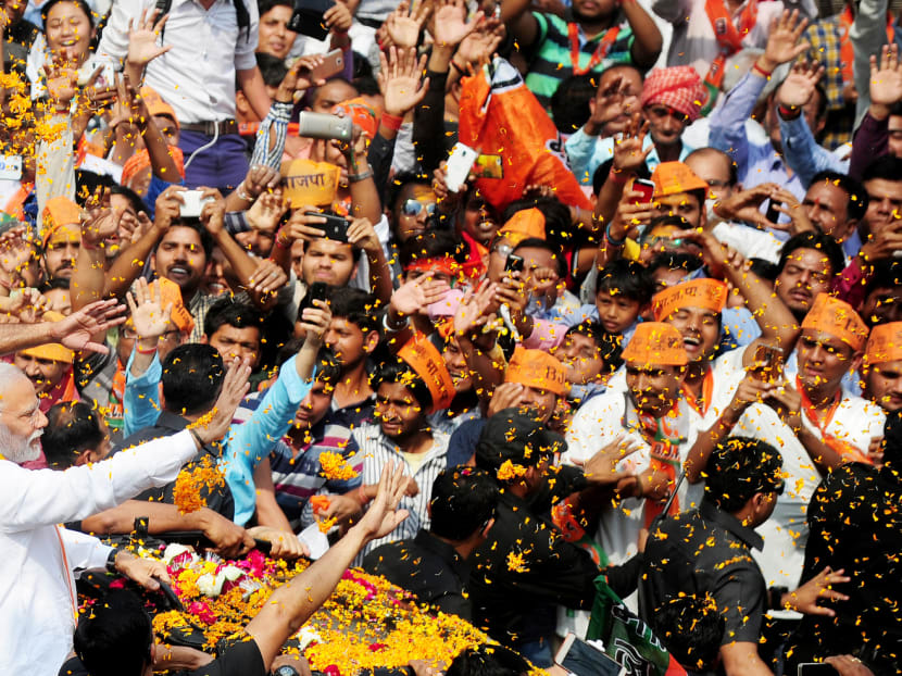 Indian Prime Minister Narendra Modi and leader of the Bharatiya Janata Party (BJP) being greeted by supporters during campaigning in Varanasi on Saturday. Photo: AFP