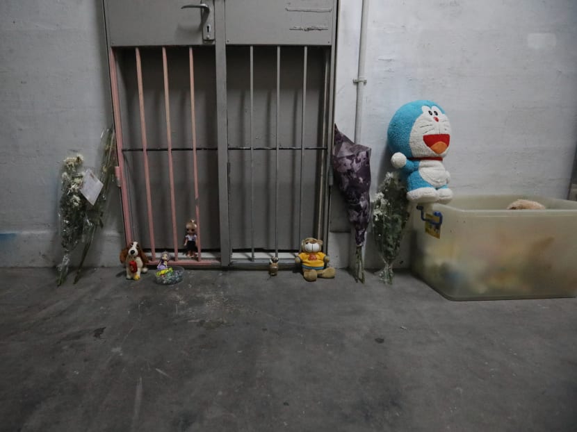 Flowers, toys and sweets left outside the Chin Swee Road rental flat where the remains of a toddler were found two weeks ago. Photos have surfaced on Facebook purportedly showing the couple accused of killing their child in the flat.