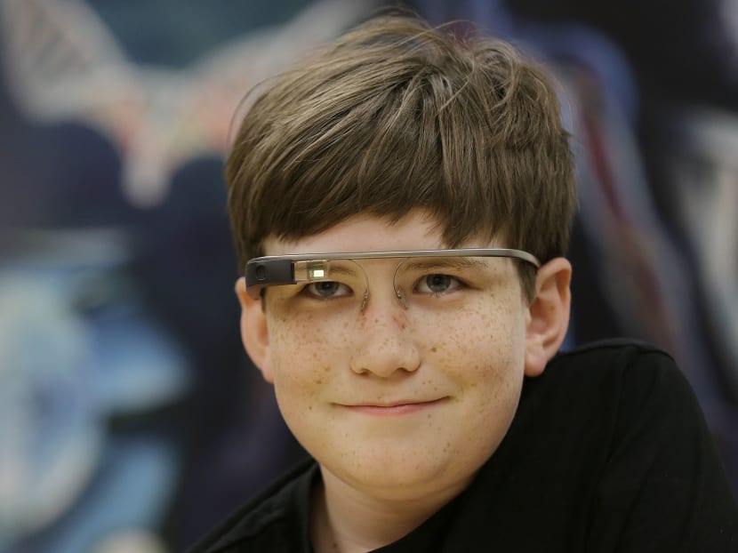Julian Brown smiles while wearing Google Glass glasses and talking with Jena Daniels, a clinical research coordinator at The Wall Lab in Stanford, Calif., Wednesday, June 22, 2016. Photo: AP