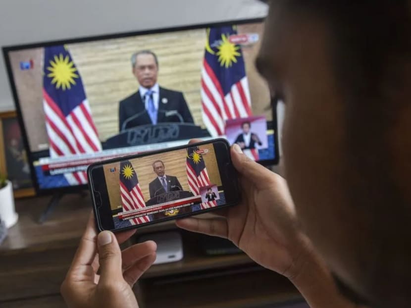 A man watches a live telecast of Malaysian prime minister Muhyiddin Yassin's speech in Kuala Lumpur on Tuesday, Jan 12, 2020.