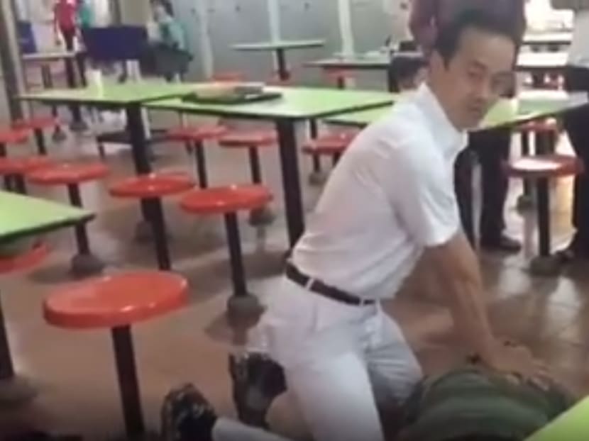 A screen capture of a video sent in by eyewitness Leng Chong showing PAP's Koh Poh Koon performing CPR on a man who collapsed while he was on a walkabout in Ang Mo Kio.