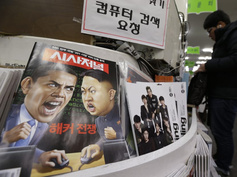 A magazine with cartoons of US  President Barack Obama, left, and North Korean leader Kim Jong Un is displayed at a book store in Seoul, South Korea, Saturday, Jan. 3, 2015. Photo: AP