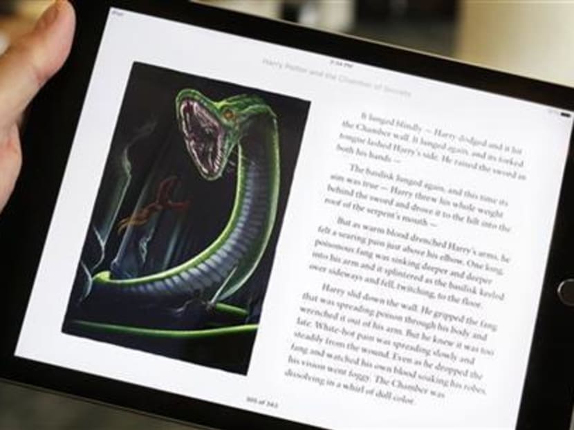 Text and an illustration from "Harry Potter and the Chamber of Secrets" are displayed on an iPad. Photo: AP