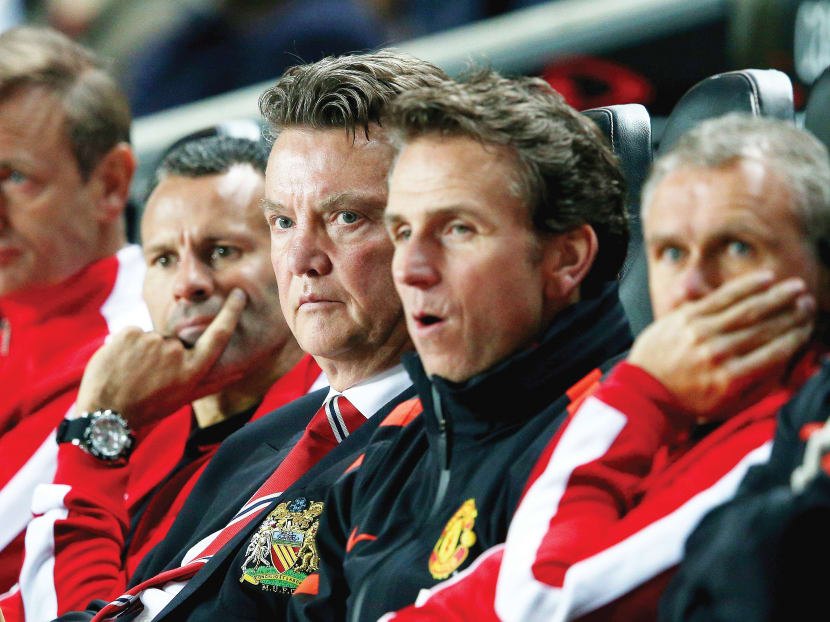 Van Gaal (centre) and his coaching team have to start reinforcing where it is really needed. PHOTO: GETTY IMAGES