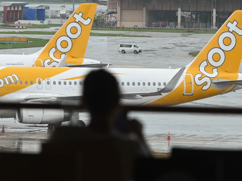 Scoot passenger planes are parked on the tarmac next to the terminal at Changi International Airport in Singapore on Jan 7, 2021.