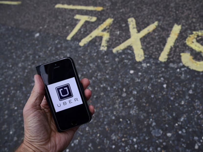 A photo illustration shows the Uber app logo displayed on a mobile telephone. Photo: Reuters