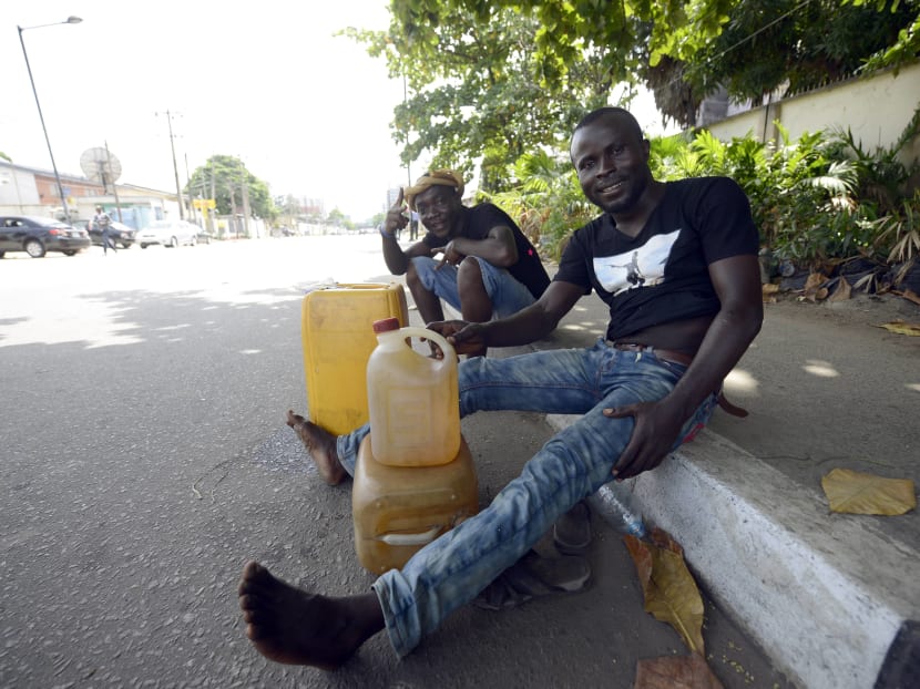 Vendors hawk fuel by the roadside in Lagos. Photo: AFP